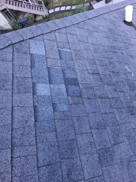 Patch of new shingles blended into an existing shingle roof field