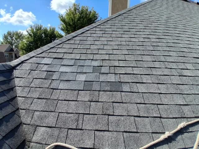 Same roof repaired, new matching shingles filling the section
