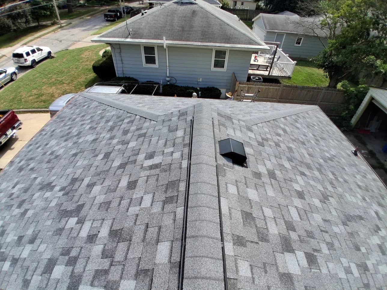 Aerial view of a finished hip roof with new Owens Corning Duration architectural shingles, Des Moines